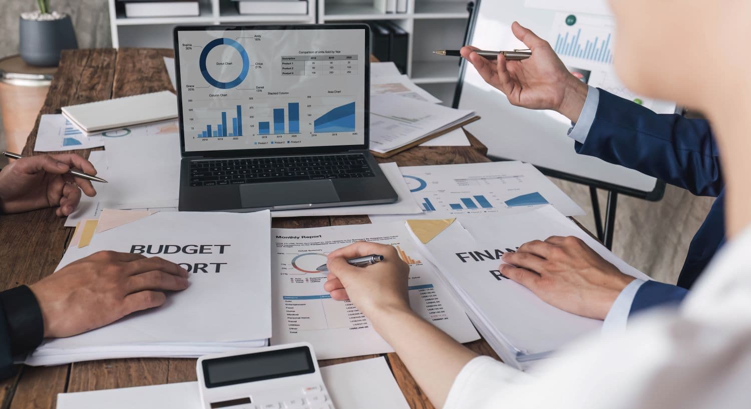 Echipă analizând rapoarte financiare și grafice